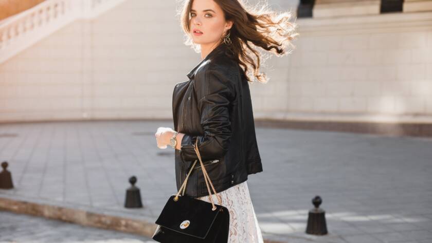 attractive woman walking in street in fashionable outfit